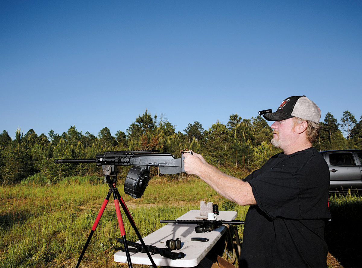 Shouse tests a Saiga-12 semiautomatic shotgun at a backyard firing range.
