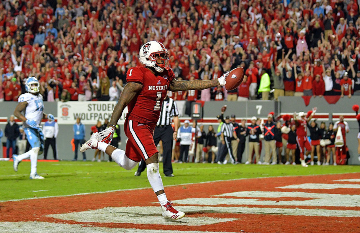 Jaylen Samuels #1 of the North Carolina State Wolfpack scores the game-clinching touchdown late in the fourth quarter of their game against the North Carolina Tar Heels at Carter Finley Stadium on November 25, 2017 in Raleigh, North Carolina. North Carolina State won 33-21. (Photo by Grant Halverson/Getty Images)