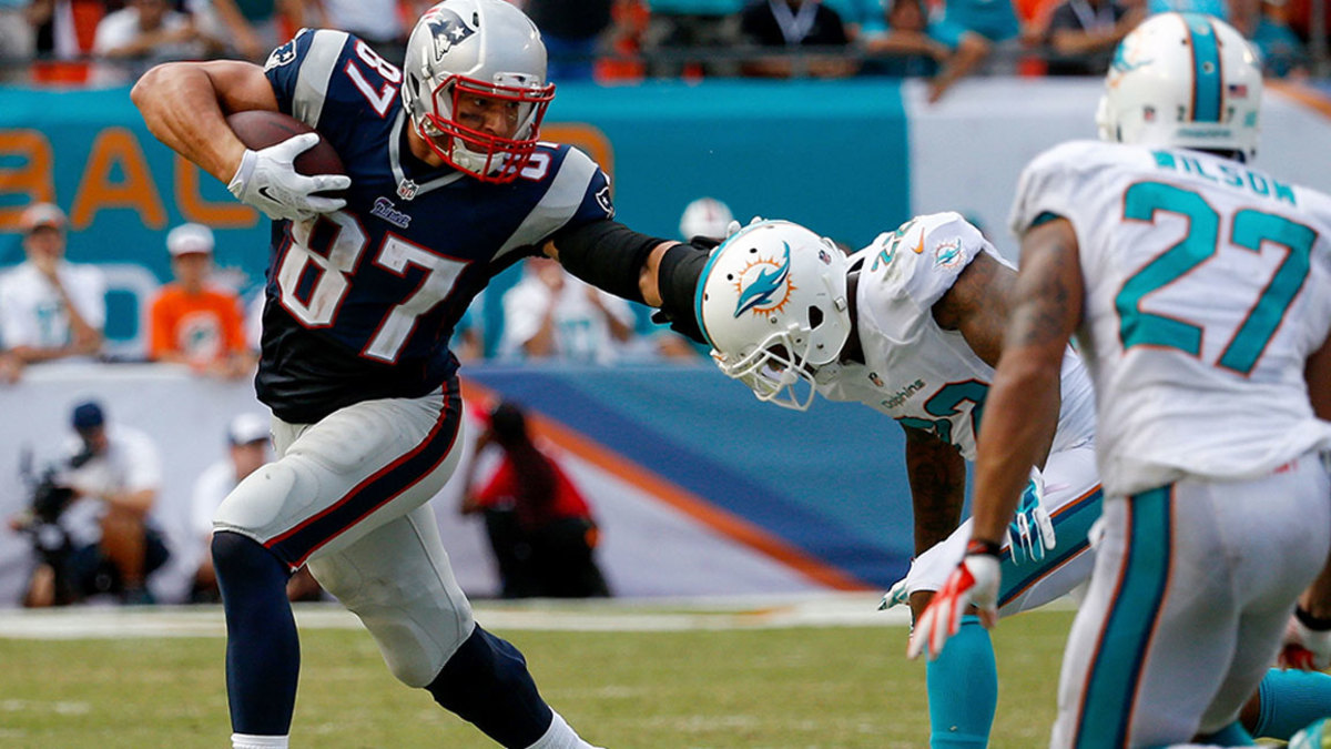 Rob Gronkowski #87 of the New England Patriots stiff-arms Jamar Taylor #22 of the Miami Dolphins during the second half of the game Sun Life Stadium on September 7, 2014 in Miami Gardens, Florida. (Photo by Rob Foldy/Getty Images)