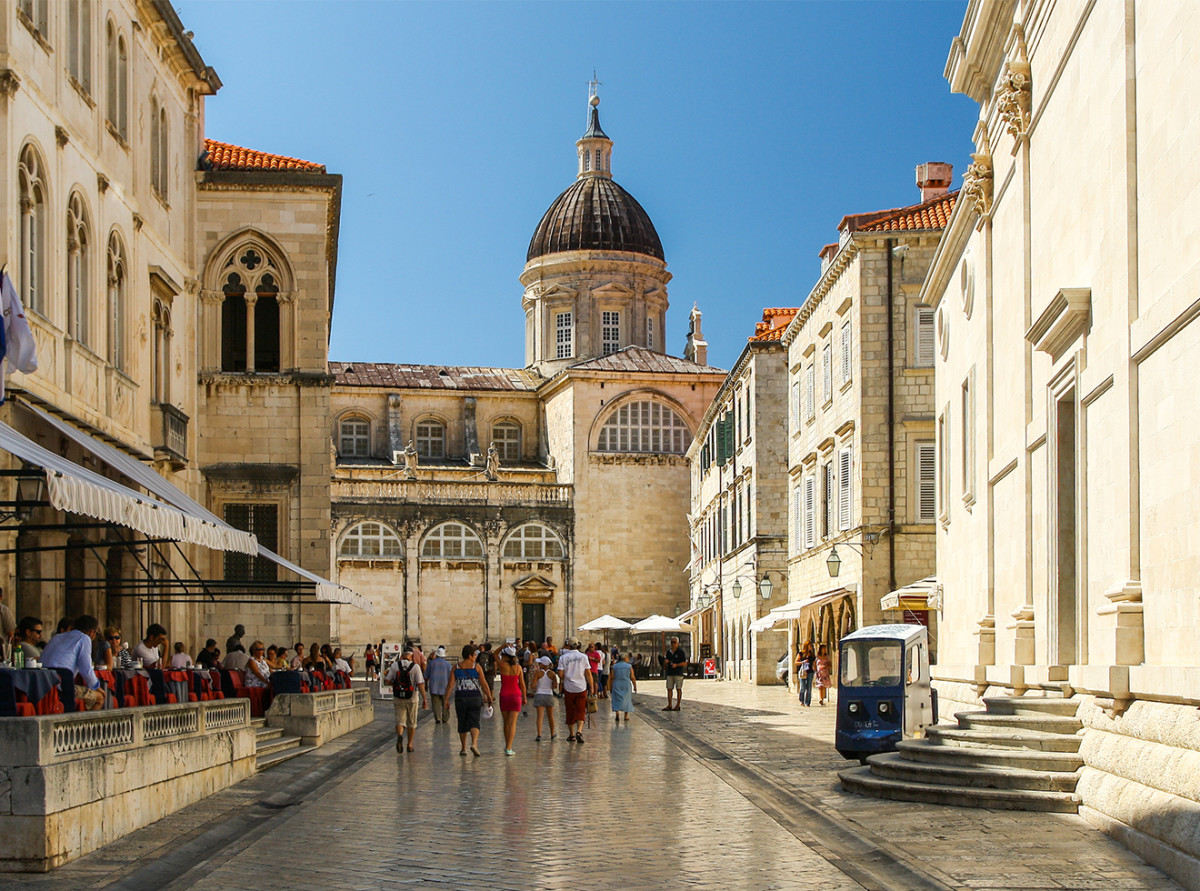 Tourists strolling near the cathedral in the Old City of Dubrovnik, Croatia