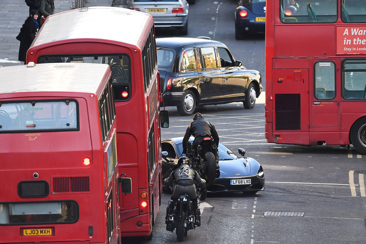 A stunt double on a Triumph motorcycle and a McLaren sports car are driven down Cochrane Street as filming of Fast and the Furious spinoff continues on October 26, 2018 in Glasgow, Scotland. The Universal Pictures film stars Jason Statham, Dwayne Johnson and Idris Elba and has a crew of 200 working on it in the city until the 29th of October. (Photo by Jeff J Mitchell/Getty Images)