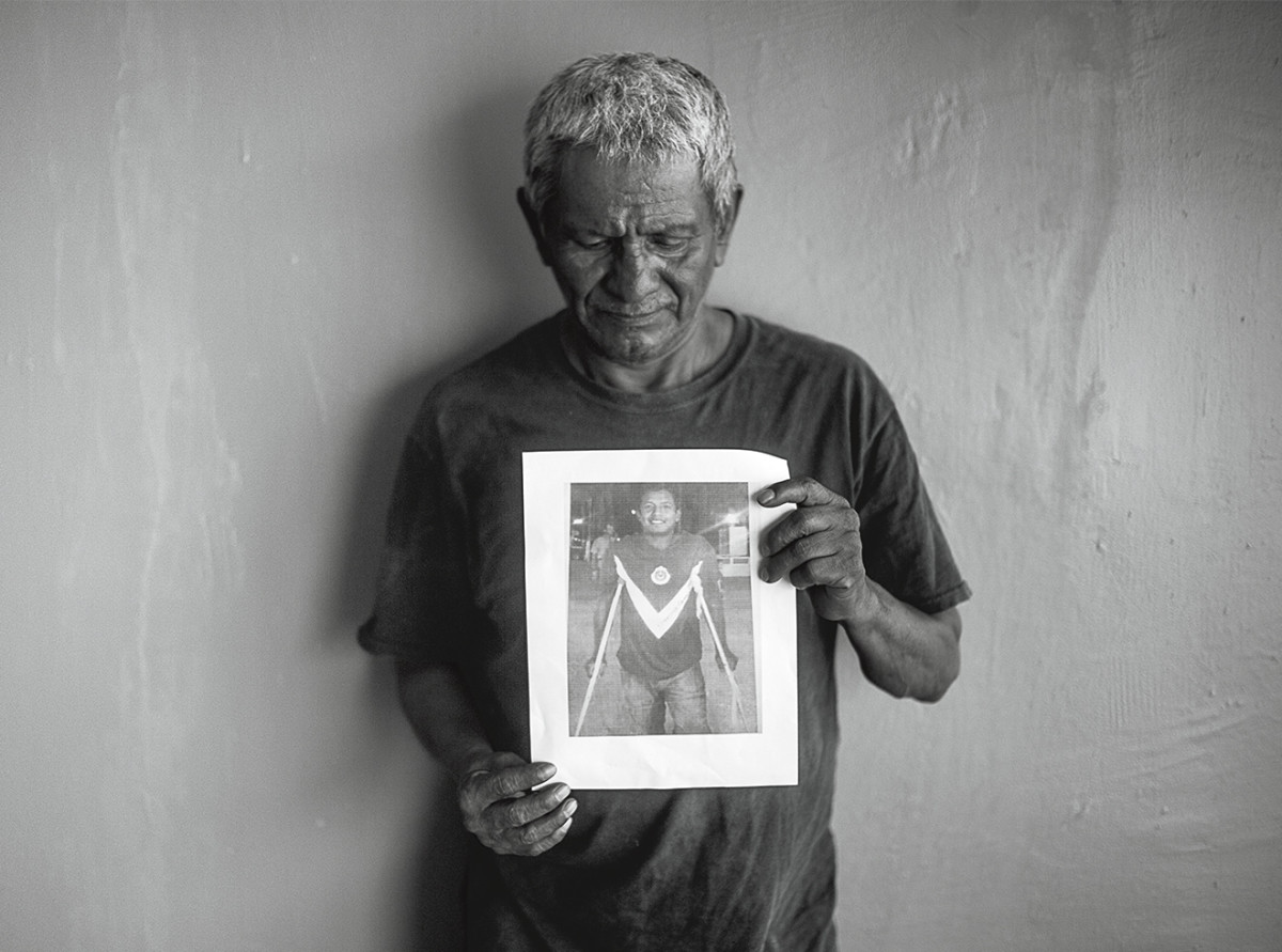 Contreras holds up a photo of his son.