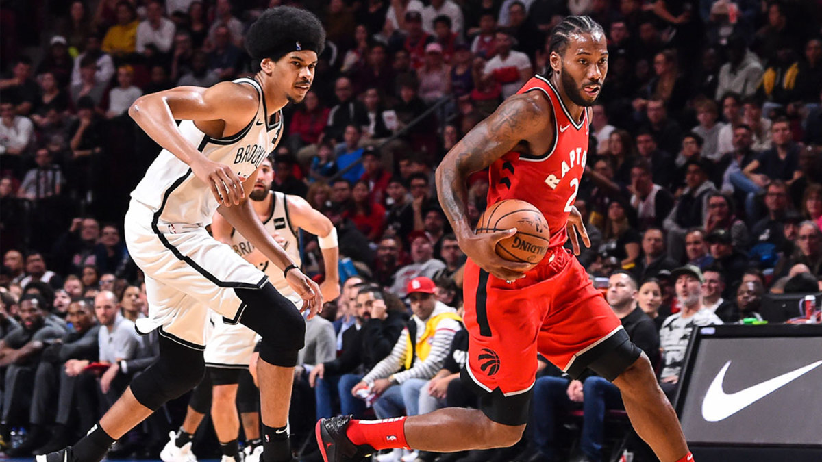 Kawhi Leonard #2 of the Toronto Raptors dribbles the ball past Jarrett Allen #31 of the Brooklyn Nets during the pre-season NBA game at the Bell Centre on October 10, 2018 in Montreal, Quebec, Canada. The Toronto Raptors defeated the Brooklyn Nets 118-91.