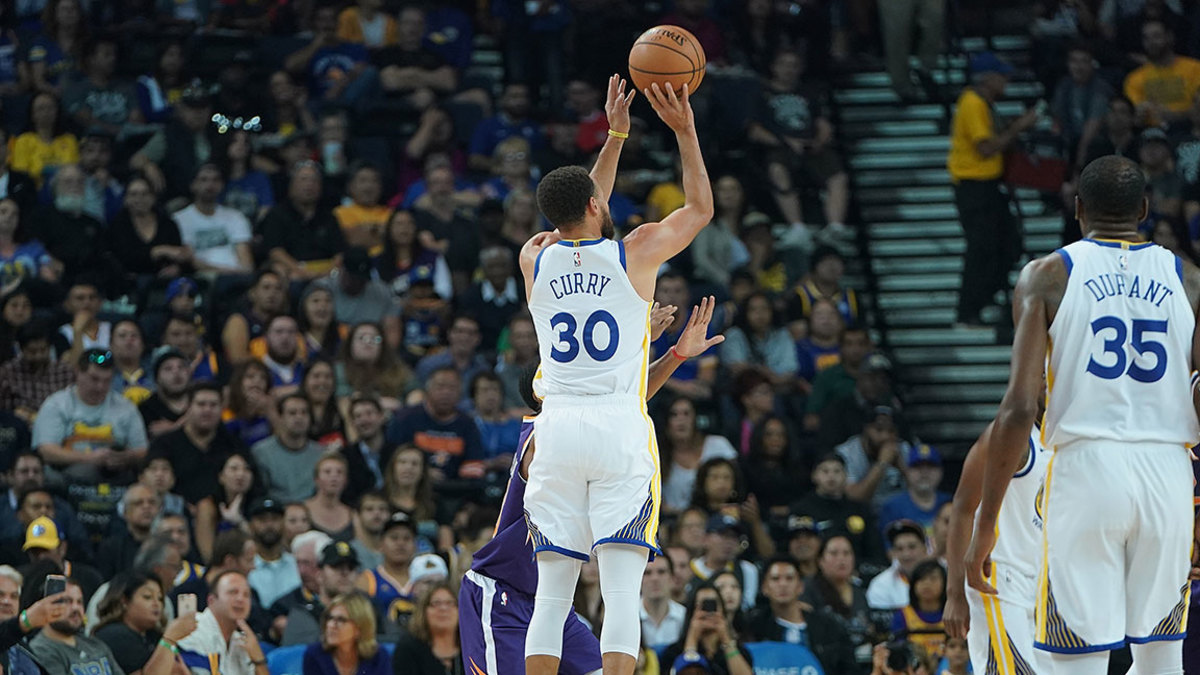 Stephen Curry #30 of the Golden State Warriors shoots a three-point shot against the Phoenix Suns during an NBA basketball game at ORACLE Arena on October 8, 2018 in Oakland, California.
