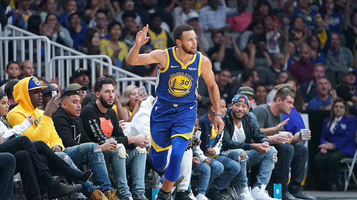 Stephen Curry #30 of the Golden State Warriors celebrates after scoring a three-point basket against the Los Angeles Lakers during the first half of their NBA preseason basketball game at SAP Center on October 12, 2018 in San Jose, California. 