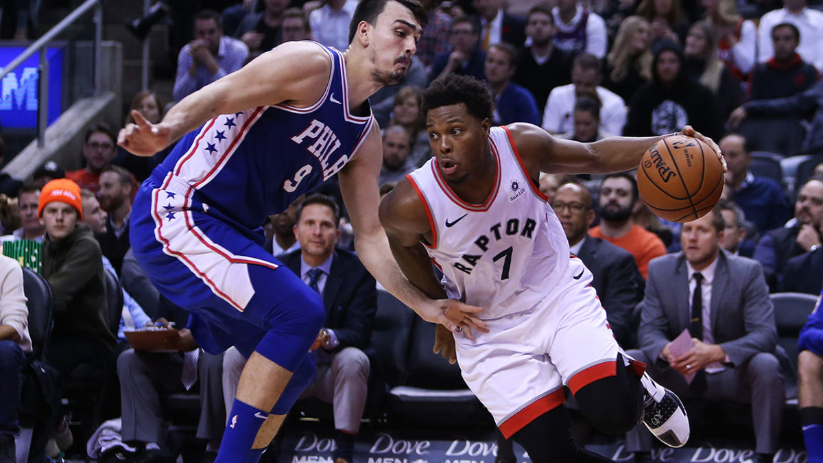Kyle Lowry #7 of the Toronto Raptors dribbles the ball as Dario Saric #9 of the Philadelphia 76ers defends during the second half of an NBA game at Scotiabank Arena on October 30, 2018 in Toronto, Canada. NOTE TO USER: User expressly acknowledges and agrees that, by downloading and or using this photograph, User is consenting to the terms and conditions of the Getty Images License Agreement. (Photo by Vaughn Ridley/Getty Images)