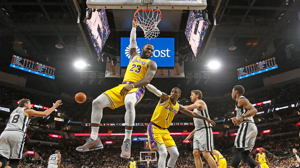 LeBron James #23 of the Los Angeles Lakers hangs onto the rim after a turnover at AT&T Center on October 27 , 2018 in San Antonio, Texas. NOTE TO USER: User expressly acknowledges and agrees that , by downloading and or using this photograph, User is consenting to the terms and conditions of the Getty Images License Agreement. (Photo by Ronald Cortes/Getty Images)
