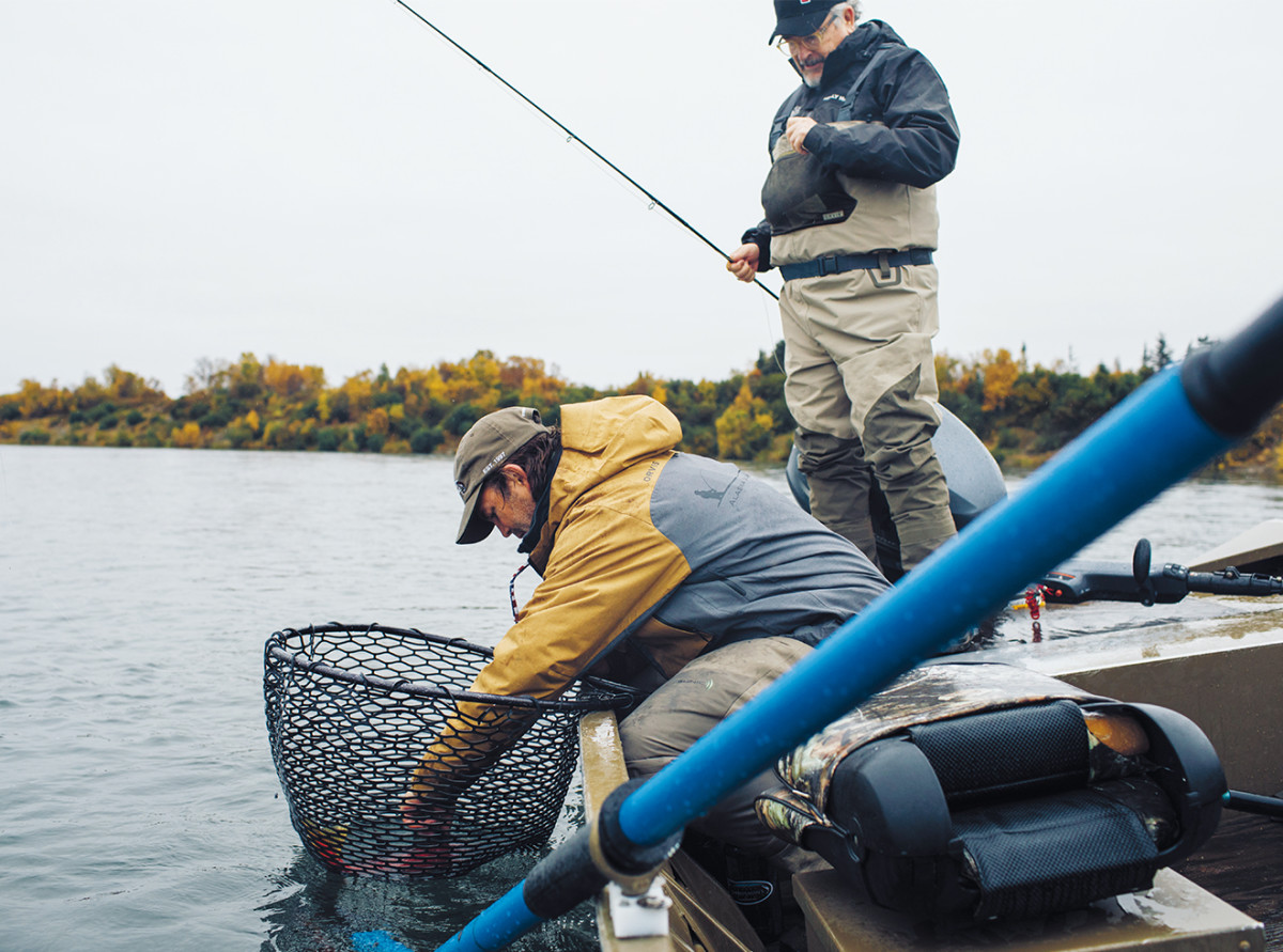 Kraft helps Collier unhook a sockeye salmon during a day pf fishing on the Kvichak River, a waterway downstream from the proposed Pebble Mine.