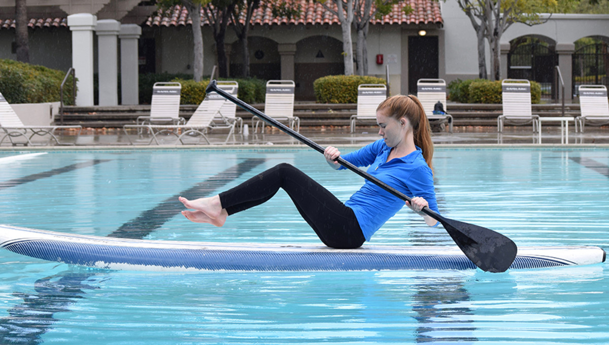Woman doing a core workout on a paddleboard