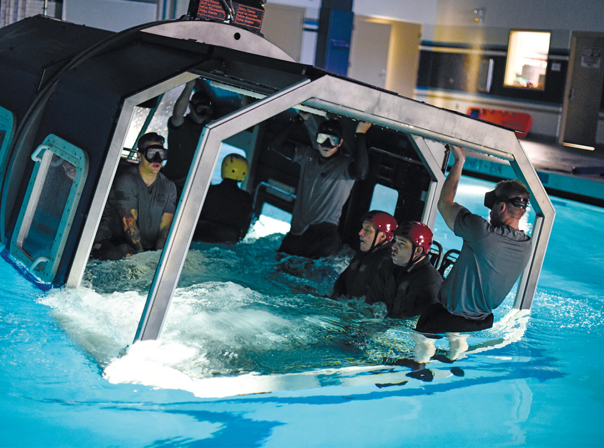 As part of training, SERE specialists practice freeing themselves from a downed aircraft in water.