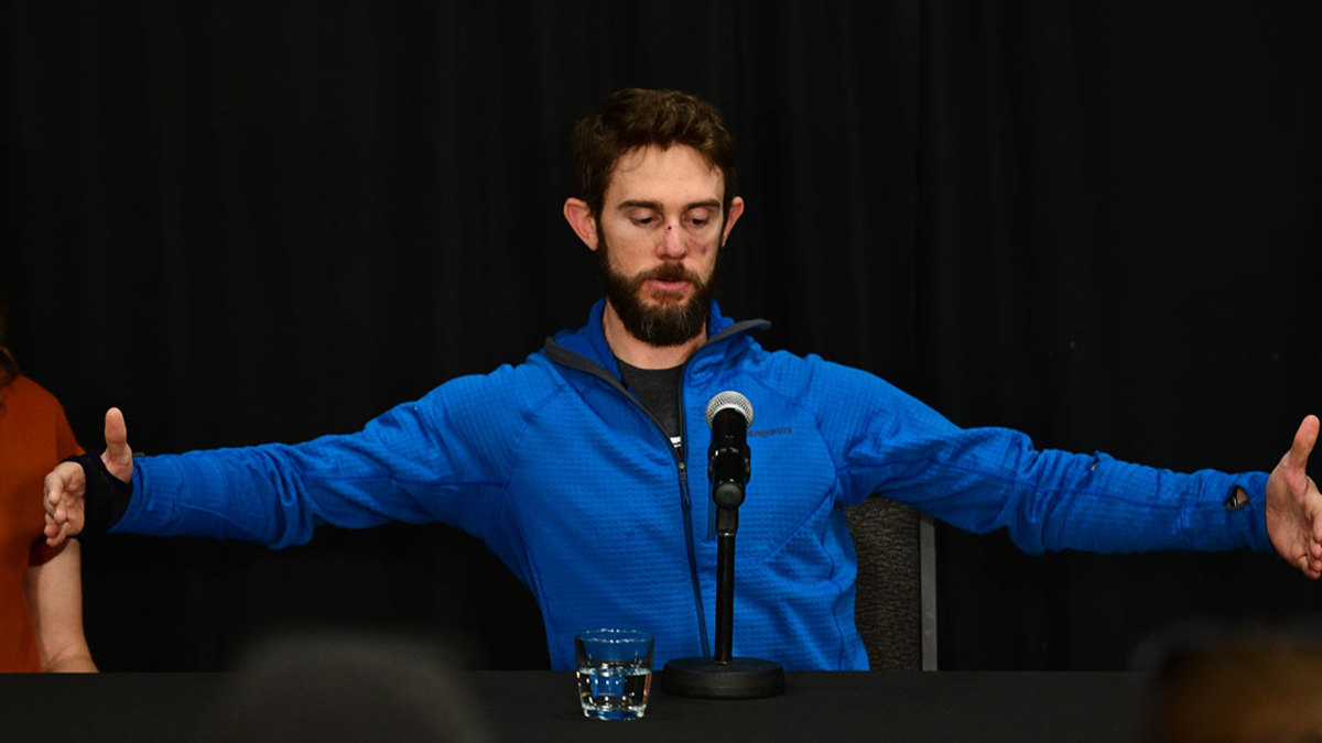 Trail runner Travis Kauffman, 31, explains the size of the mountain lion during the press conference at Fort Collins Marriott hotel. Feb. 14, 2019. Kauffman survived a mountain lion attack and then killed the animal with his bare hands. Kauffman received more than 20 stitches to his face, and suffered contusions and puncture wounds to his neck and legs that did not require stitches. Feb. 14, 2019. (Photo by Hyoung Chang/MediaNews Group/The Denver Post via Getty Images)