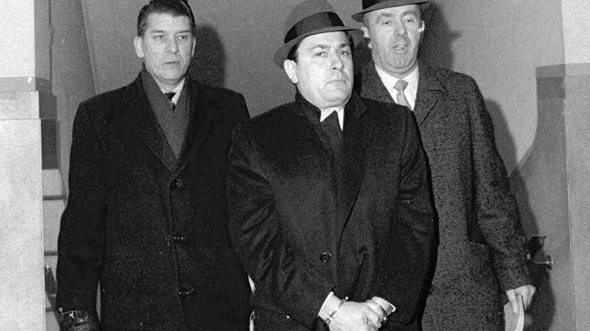 UNITED STATES - MARCH 06: Handcuffed Joe Colombo Sr. arrives at Nassau District Attorney William Cahn's Mineola, L.I., office after arrest. (Photo by Jim Mooney/NY Daily News Archive via Getty Images)