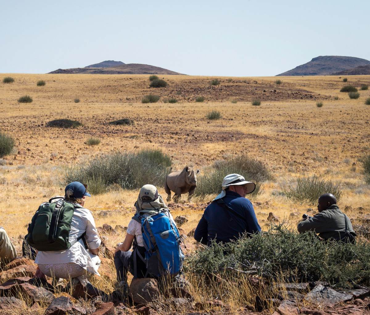Tourists on walking rhino tour at Desert Rhino Camp in Damaraland, Namibia