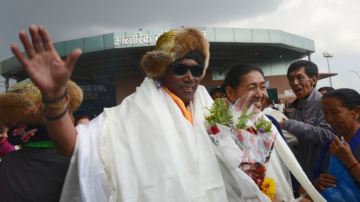 Nepali mountaineer Kami Rita Sherpa, 48, who broke his own world record for the most Everest summits, gestures after arriving in Tribhuvan airport in Nepal's capital Kathmandu on May 20, 2018. - Kami Rita Sherpa broke his own world record for the most Everest summits on May 16 by reaching the world's highest peak for the 22nd time. (Photo by PRAKASH MATHEMA / AFP) (Photo credit should read PRAKASH MATHEMA/AFP/Getty Images)