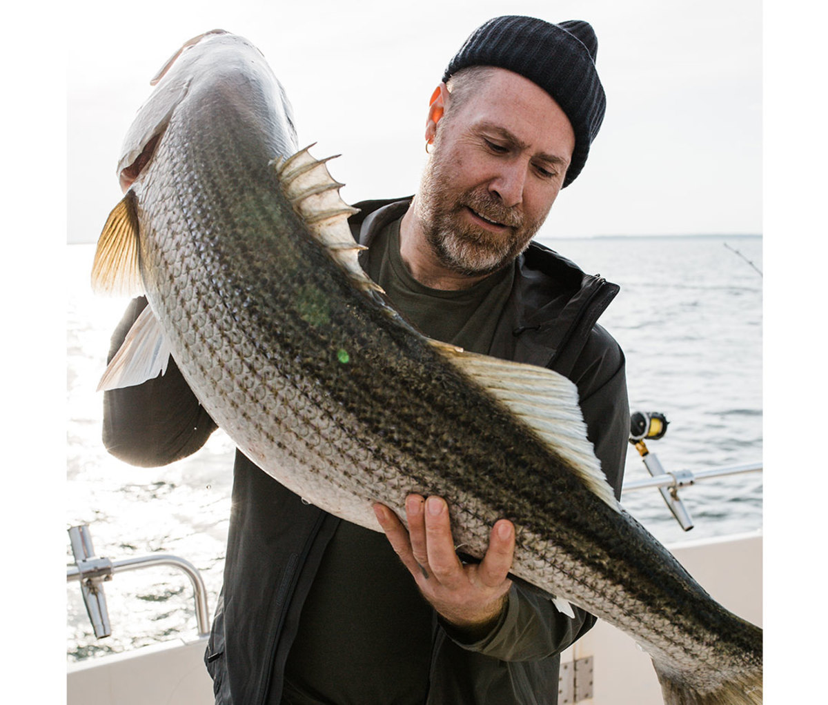 Claes Claesson holds 44-inch striped bass