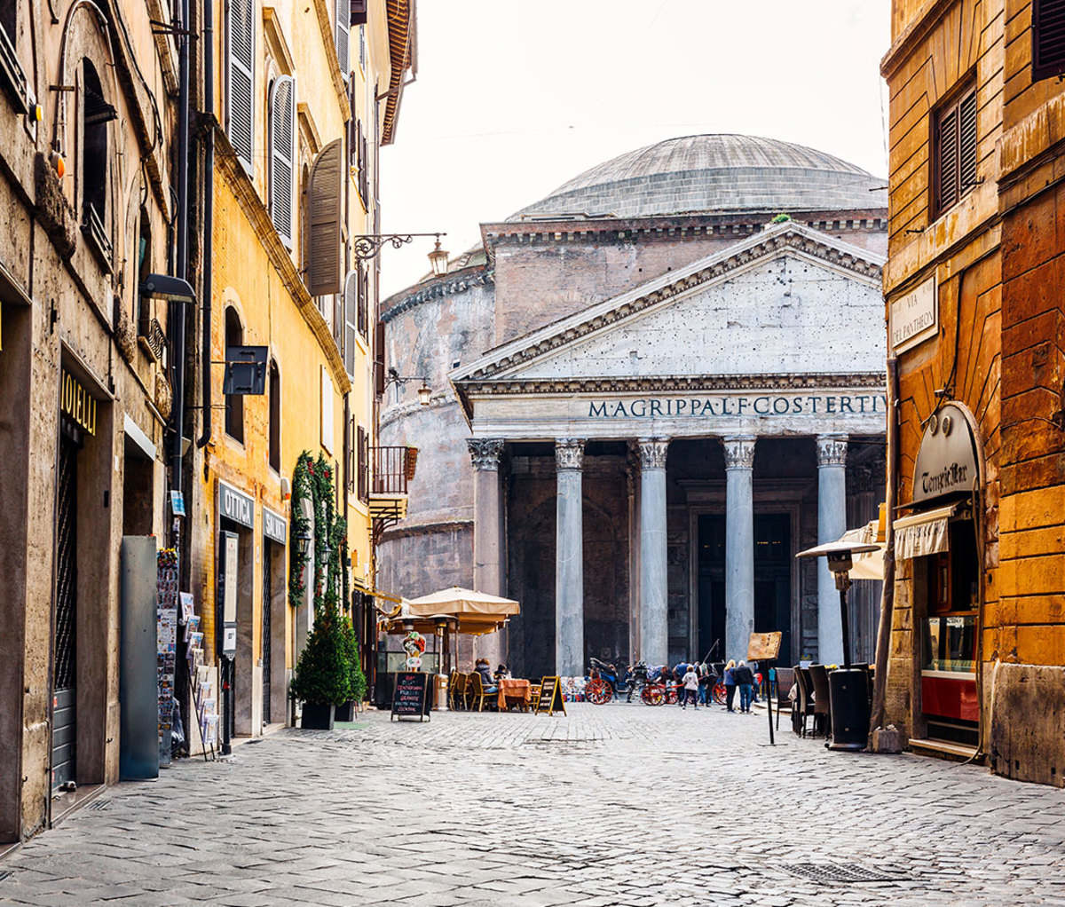 Old cobblestone street in Rome and Pantheon in the center, Italy