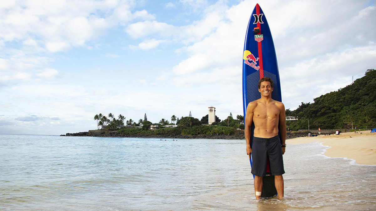 Hawaii's big wave surfer Kai Lenny poses with his board before the opening ceremony of the 2018 Eddie Aikau Big wave Invitational Surfing Event at Waimea Bay on the north shore of Oahu in Hawaii on November 29, 2018. (Photo by brian bielmann / AFP) / RESTRICTED TO EDITORIAL USE (Photo credit should read BRIAN BIELMANN/AFP/Getty Images)
