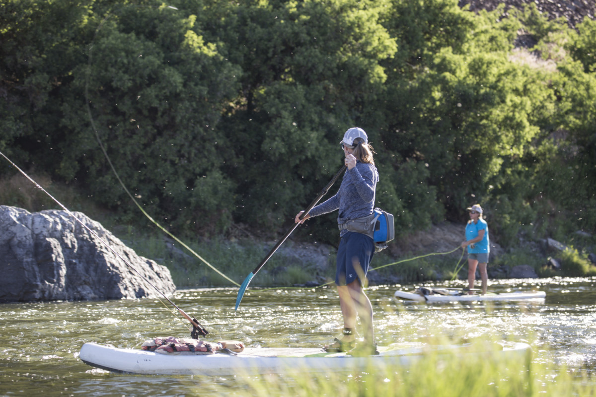 Two women fish from stand-up paddleboards on Oregon's John Day River.