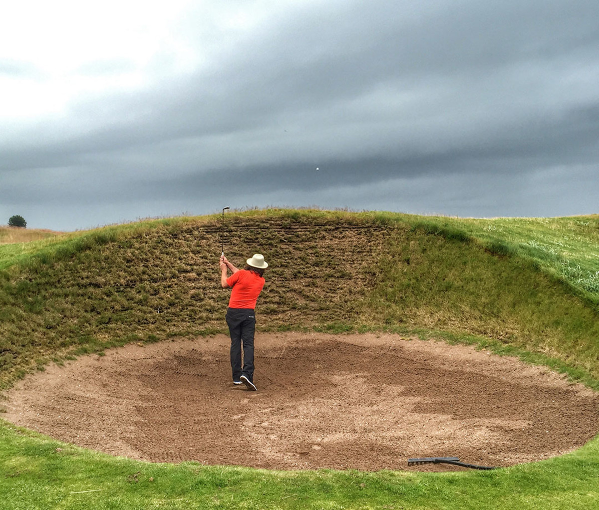 The author playing a shot from one of the twin Spectacles bunkers at Carnoustie