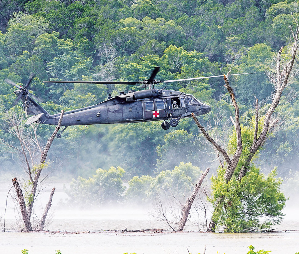An Army helicopter searches for the missing soldiers swept away in Owl Creek.