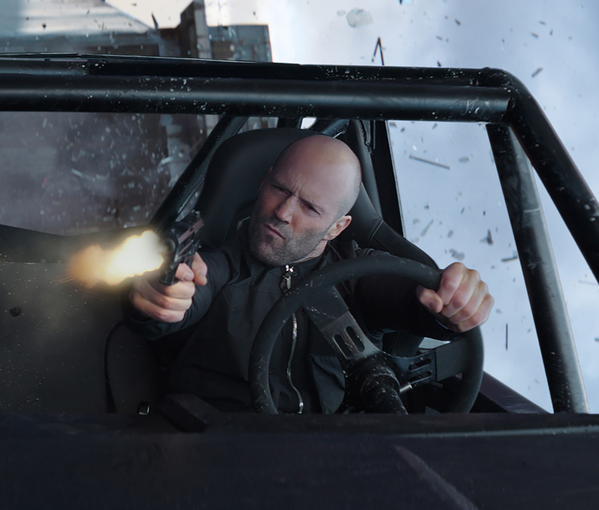 Deckard Shaw (Jason Statham) in a custom rock crawler, based on the Land Rover Defender 110, in 