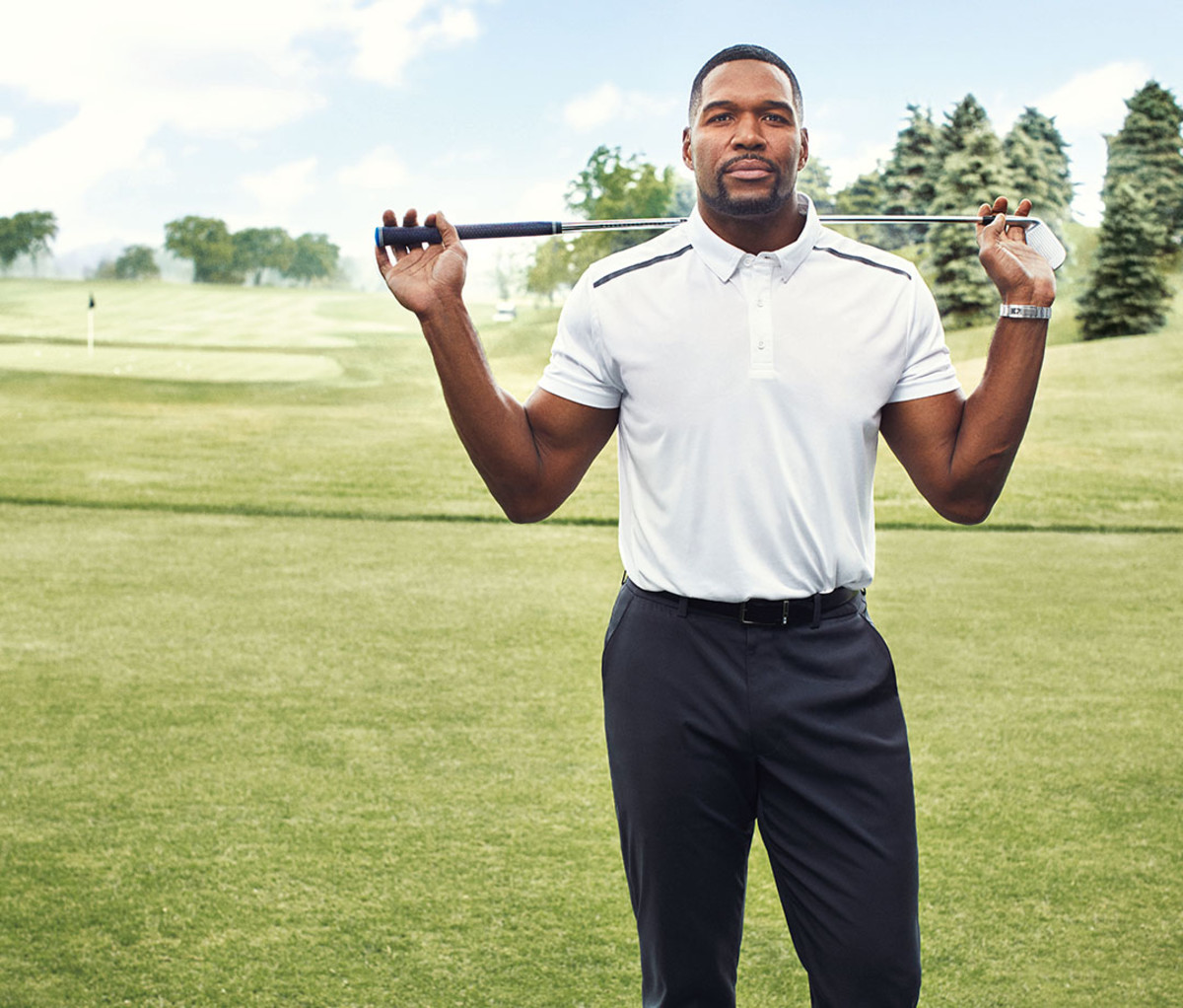 Strahan wears MSX Polo and Chino's by Michael Strahan. Watch by Rolex Daytona.