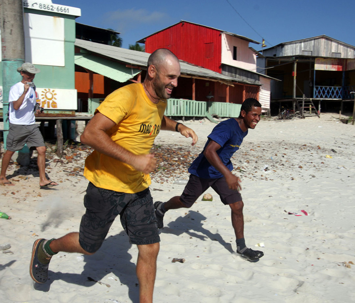 Ed Stafford and Gadiel "Cho" Sanchez Rivera run on Crispim beach in Brazil
