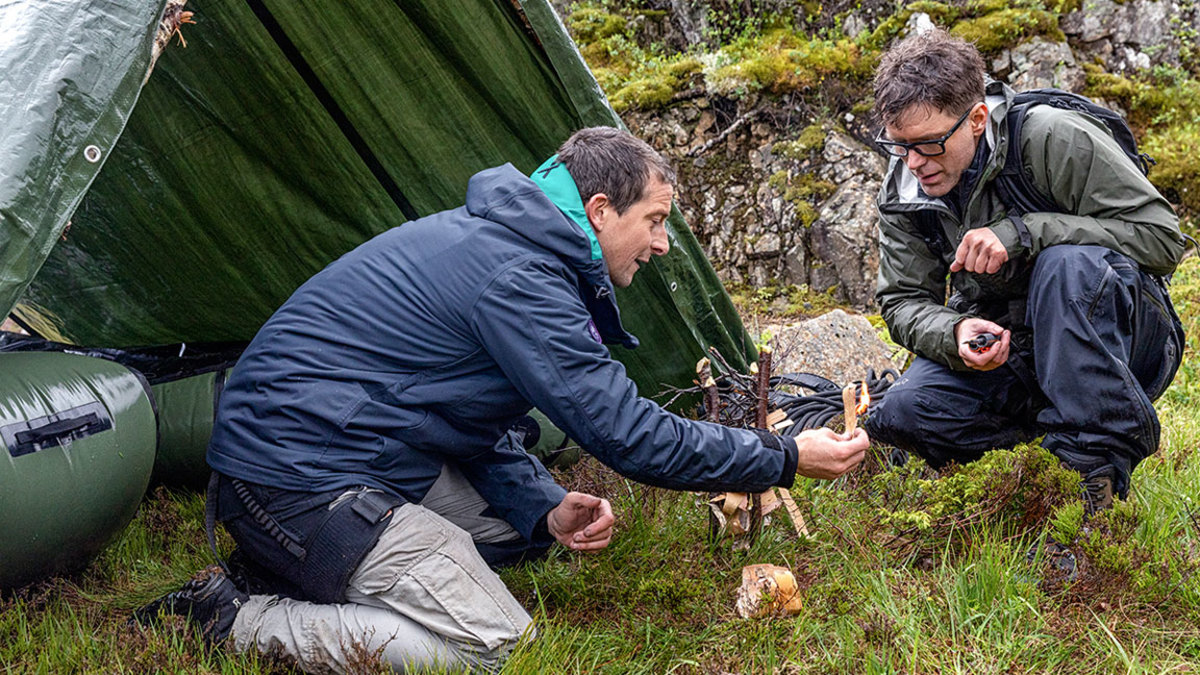 Månafossen, Norway - (L to R) Bear Grylls and Bobby Bones start a box fire in National Geographic's RUNNING WILD WITH BEAR GRYLLS. (Photo credit: National Geographic/Ben Simms)