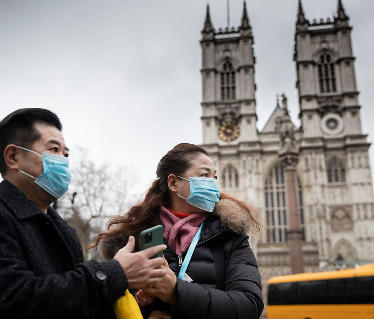 Londoners visiting Westminster Abbey wearing face masks