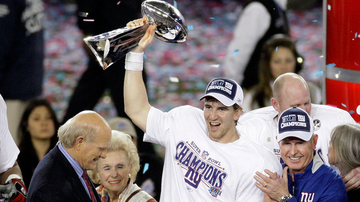 Manning Retires Football, Glendale, USA - 03 Feb 2008 Eli Manning, Tom Coughlin. New York Giants quarterback Eli Manning, center, holds the Vince Lombardi Trophy as he celebrates with his coach Tom Coughlin, right, after the Giants defeated the New England Patriots 17-14 in the Super Bowl XLII football game in Glendale, Ariz. Manning, who led the Giants to two Super Bowls in a 16-year career that saw him set almost every team passing record, has retired. The Giants said that Manning would formally announce his retirement on Friday 3 Feb 2008