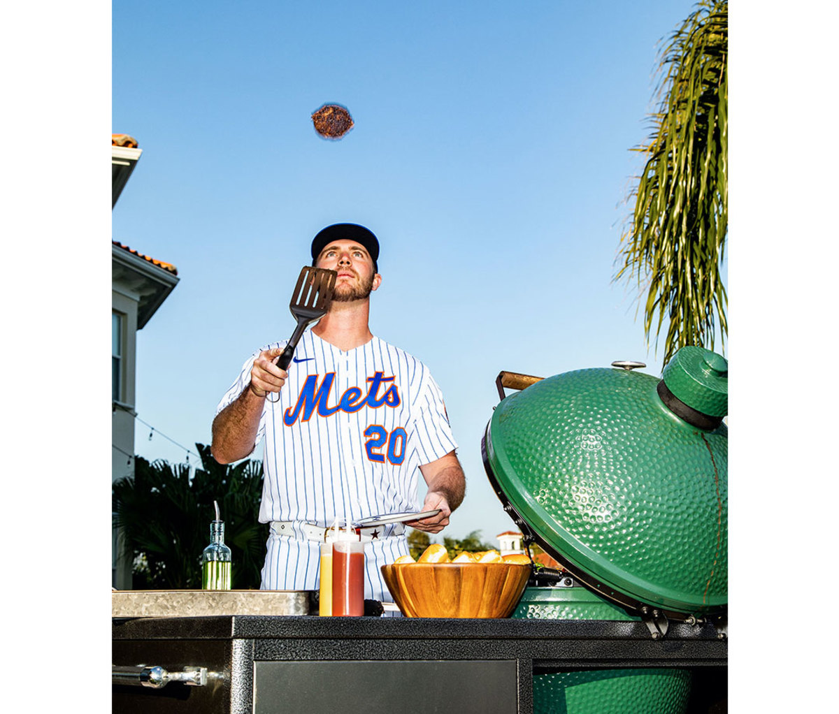 Pete Alonso flipping a hamburger