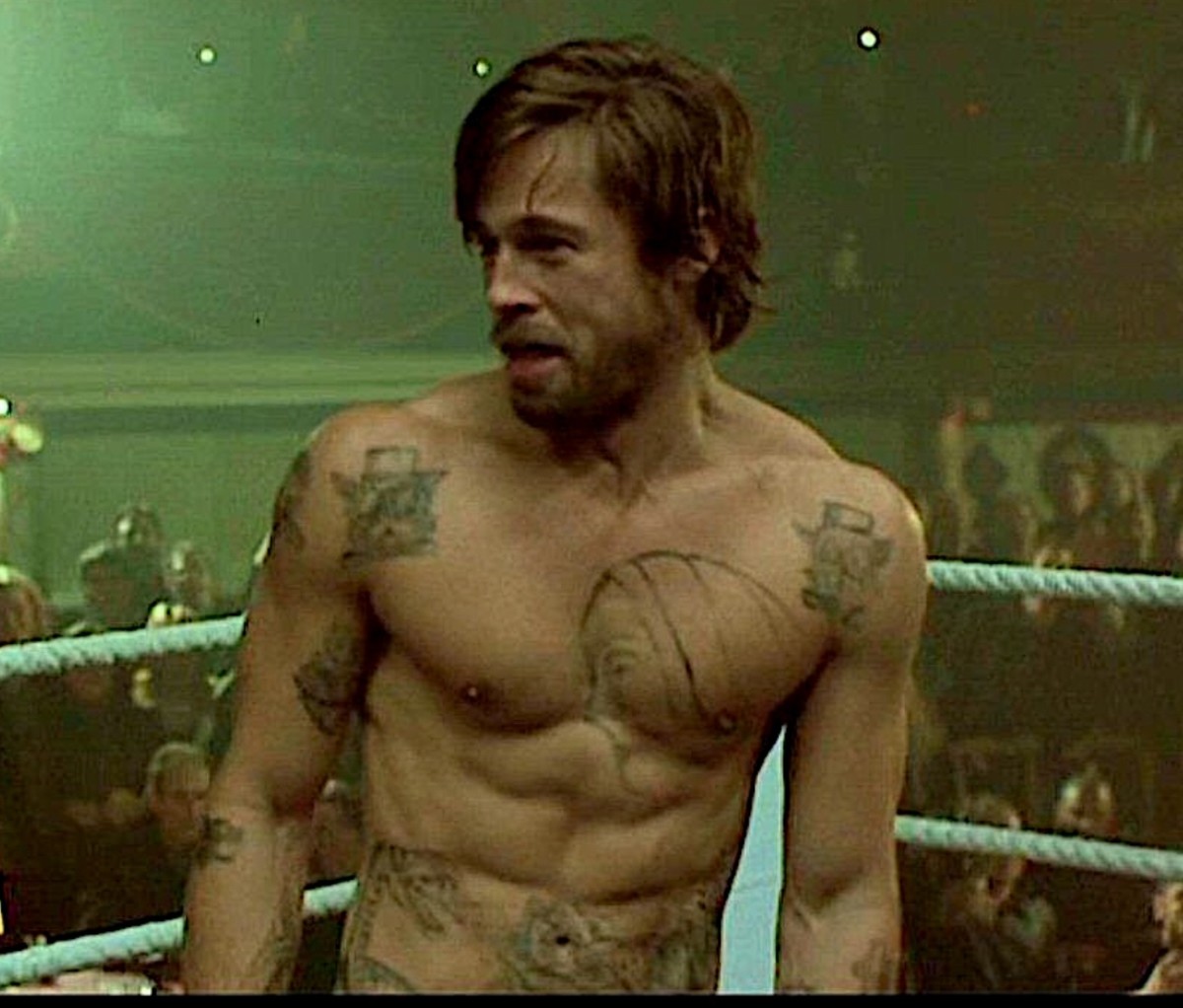 Brad Pitt as bare-knuckle boxer Mickey, sitting in a boxing ring, in 'Snatch'