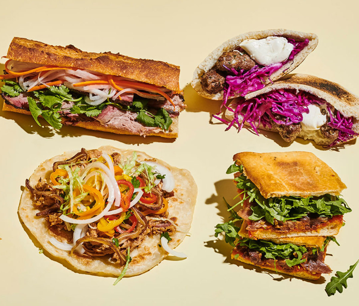 Clockwise from top left: Smoked Brisket Banh Mi, Ćevapi, Overnight Duck Confit Panini, and Pork & Peppers
