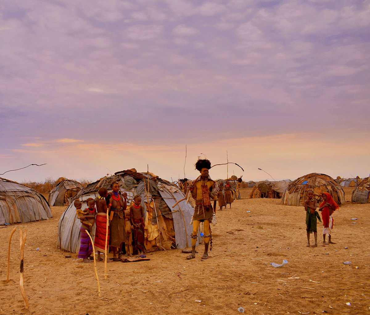 A family in the Dassanech tribe outside their home