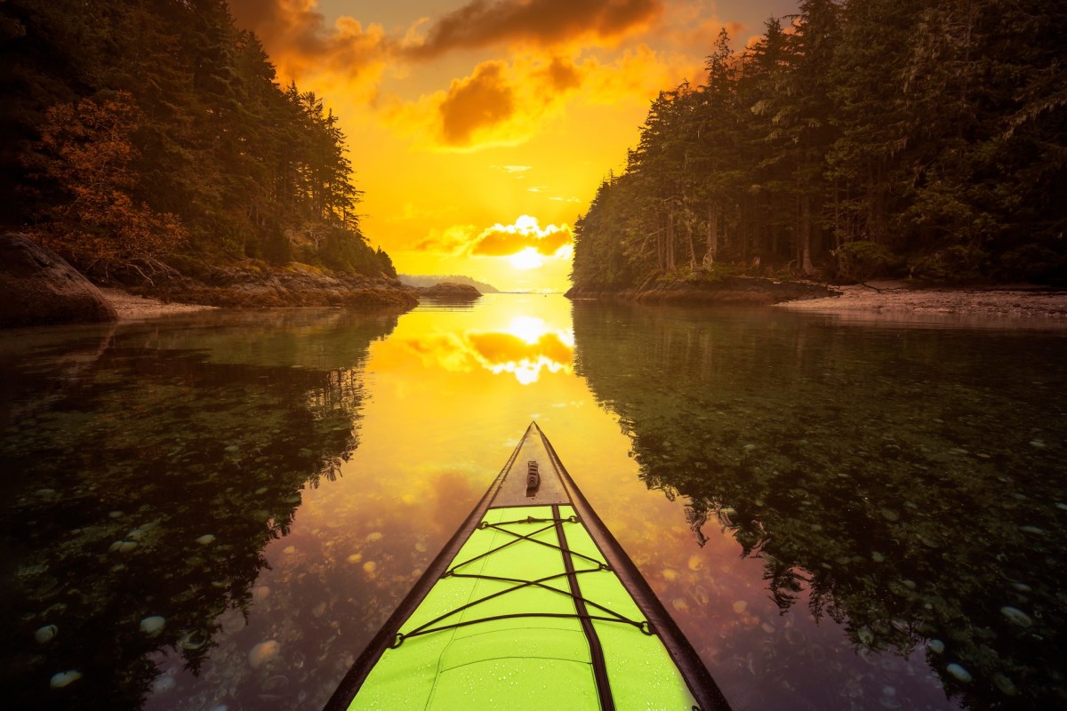 Inflatable kayaking near Port Hardy, BC, Canada, sunset