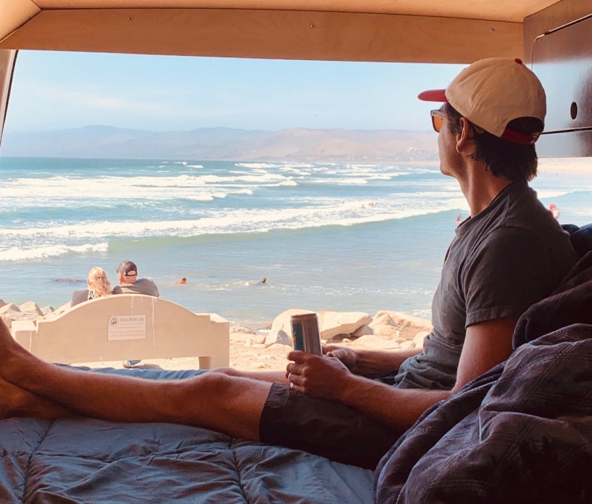 Antony Starr in camper van by the water