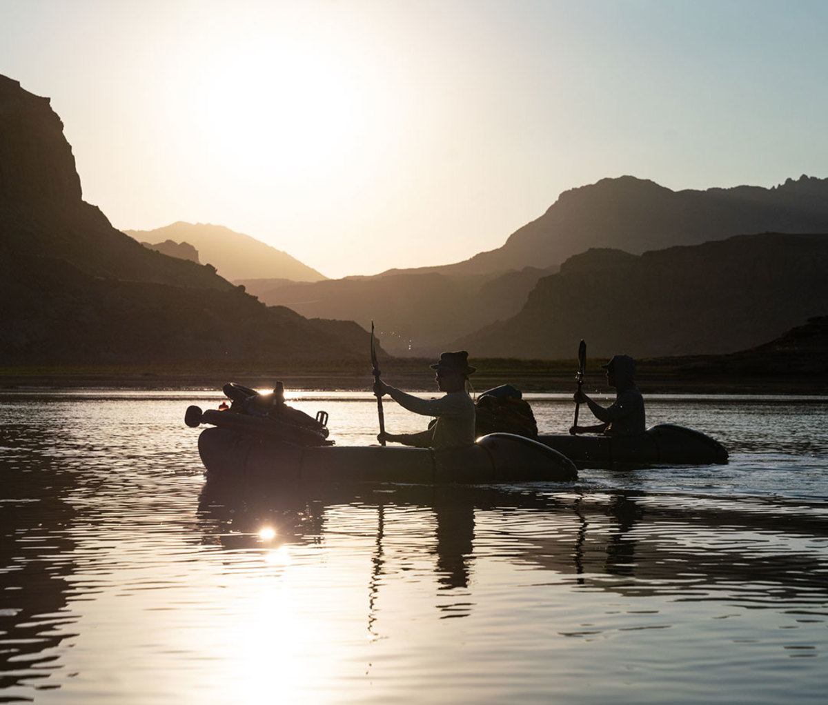 Paddling loaded packrafts on Lake Powell.