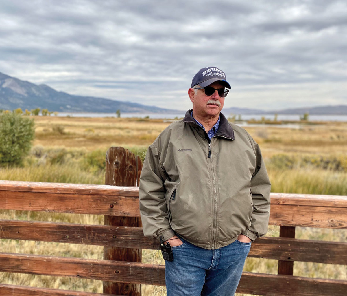 Portrait of conservationist Greg Hendriks against a fence in the countryside