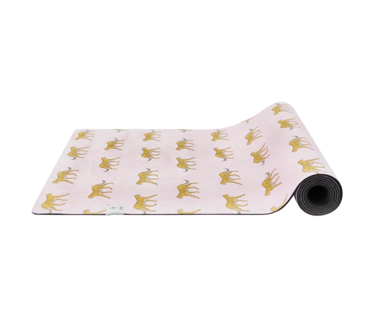 Partially rolled up Jollie Plush Mat in pink with a print of leopards on it. mother's day gifts