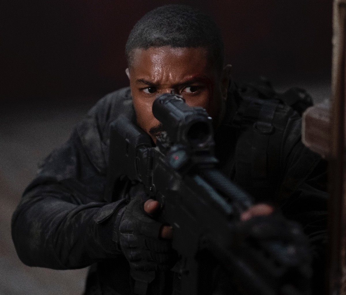 Actor Michael B. Jordan holding a rifle as a Navy SEAL in movie 'Without Remorse'