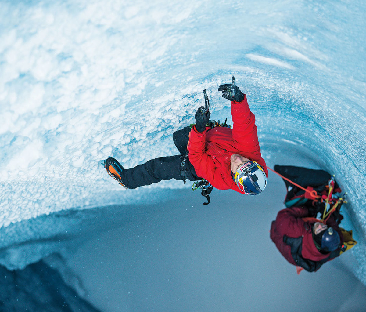 Will Gadd ice climbing in Greenland in bright red jacket