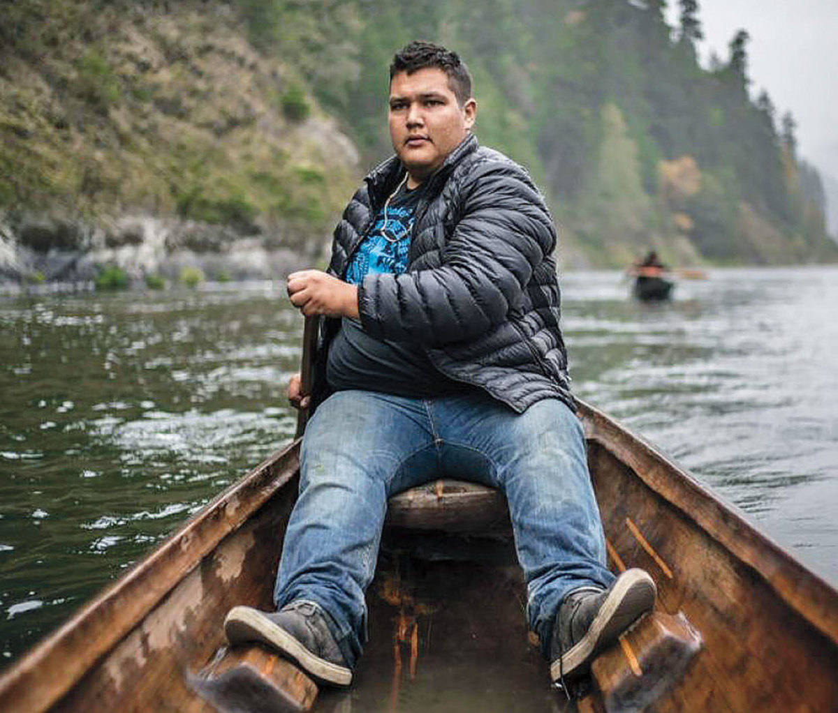 Young man rowing on Klamath river canoe
