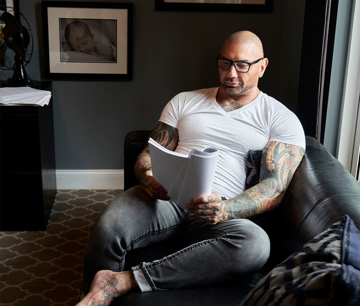 Dave Bautista reading script on couch at home