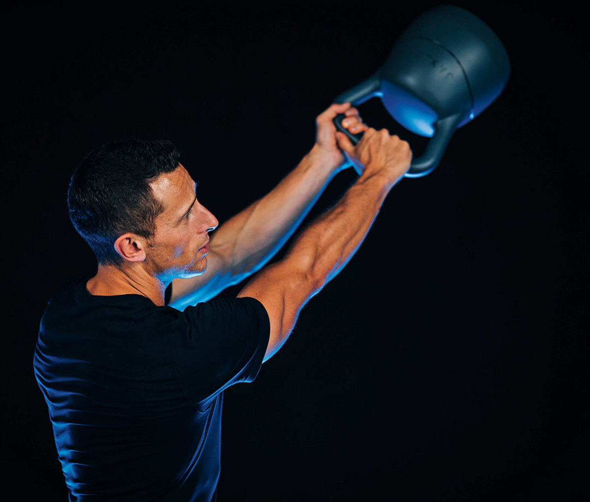 Man swinging JaxJox smart kettlebell