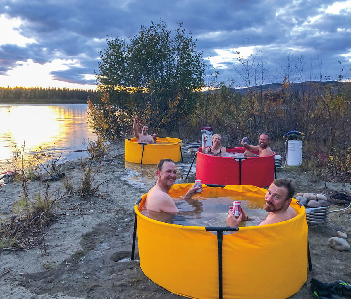 Men soaking in port-a-tubs along Yukon River.