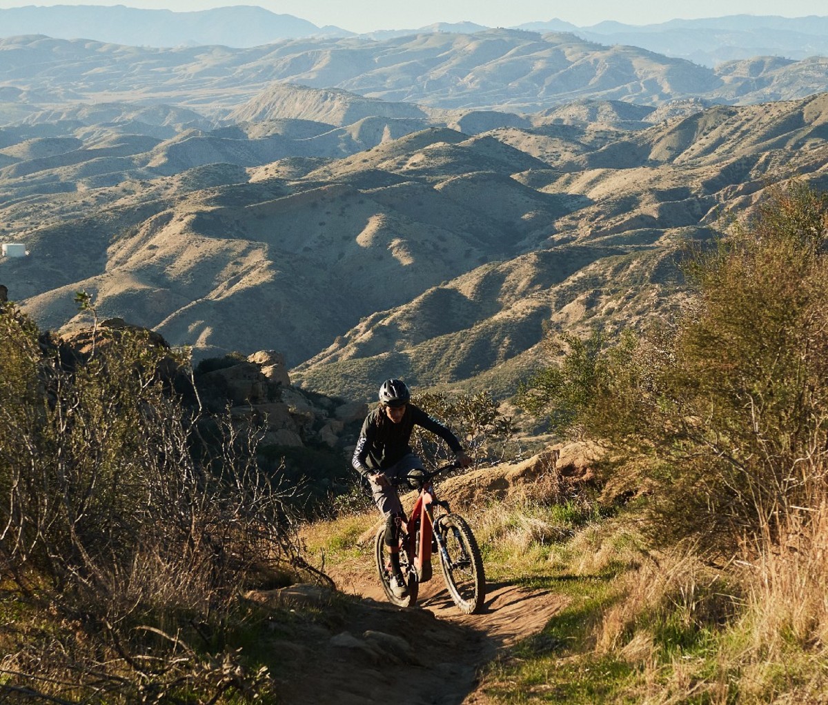 Mountain biker riding up hilly mountain