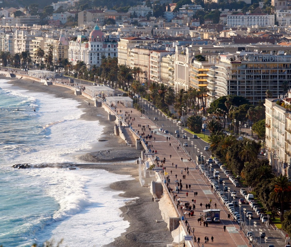 An aerial shot of Nice, France with the sea, beach, and city buildings.