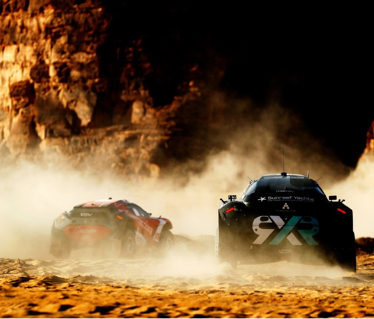 Extreme-E off-road SUVs racing in desert.