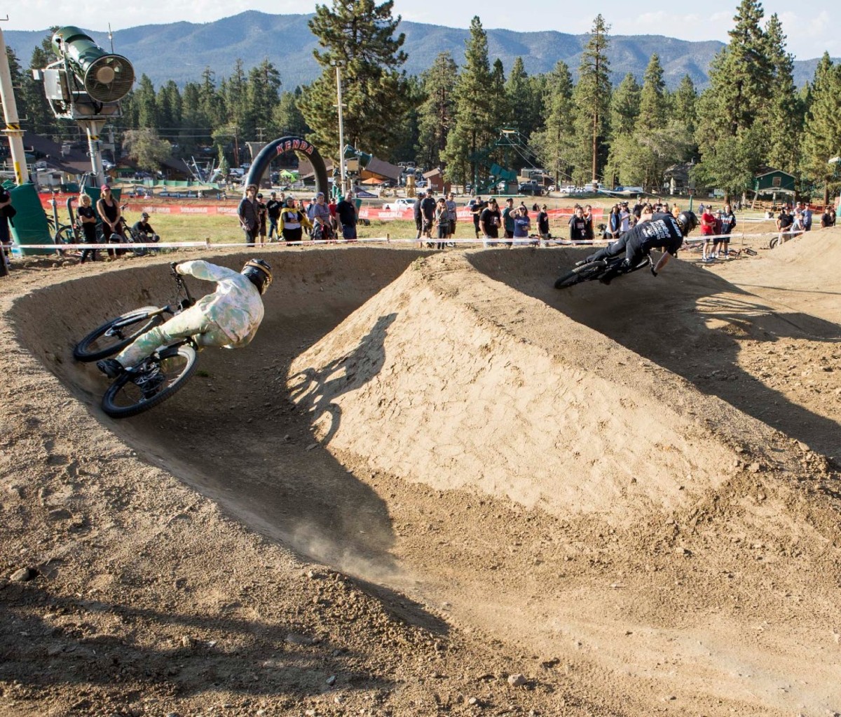 Two bike racers race through a dual track course.