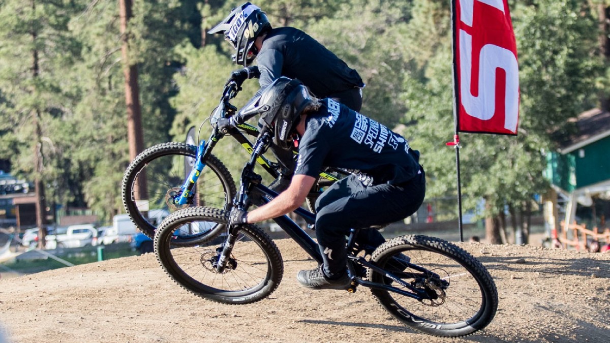 Two cyclists in a dual track.